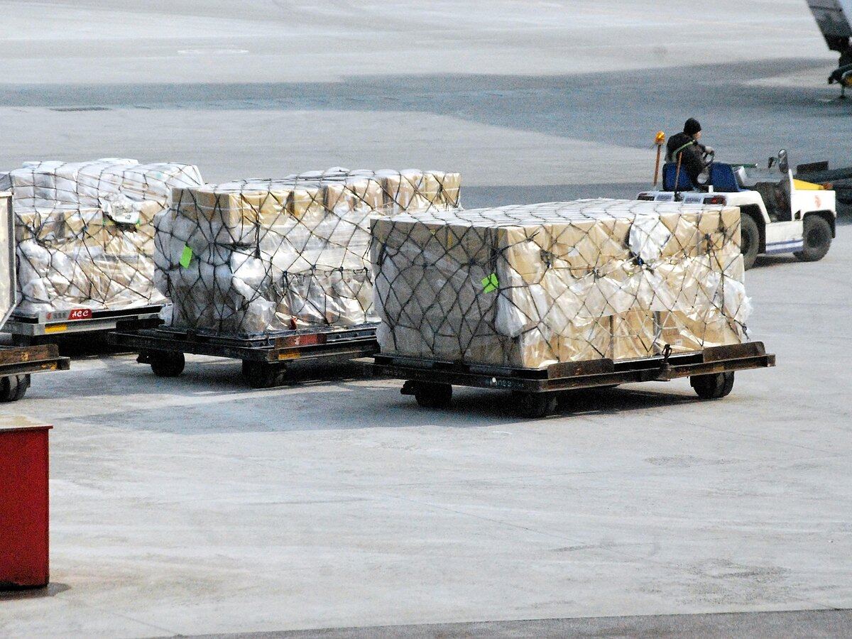 Netted air freight pallets standing on the apron waiting to be loaded