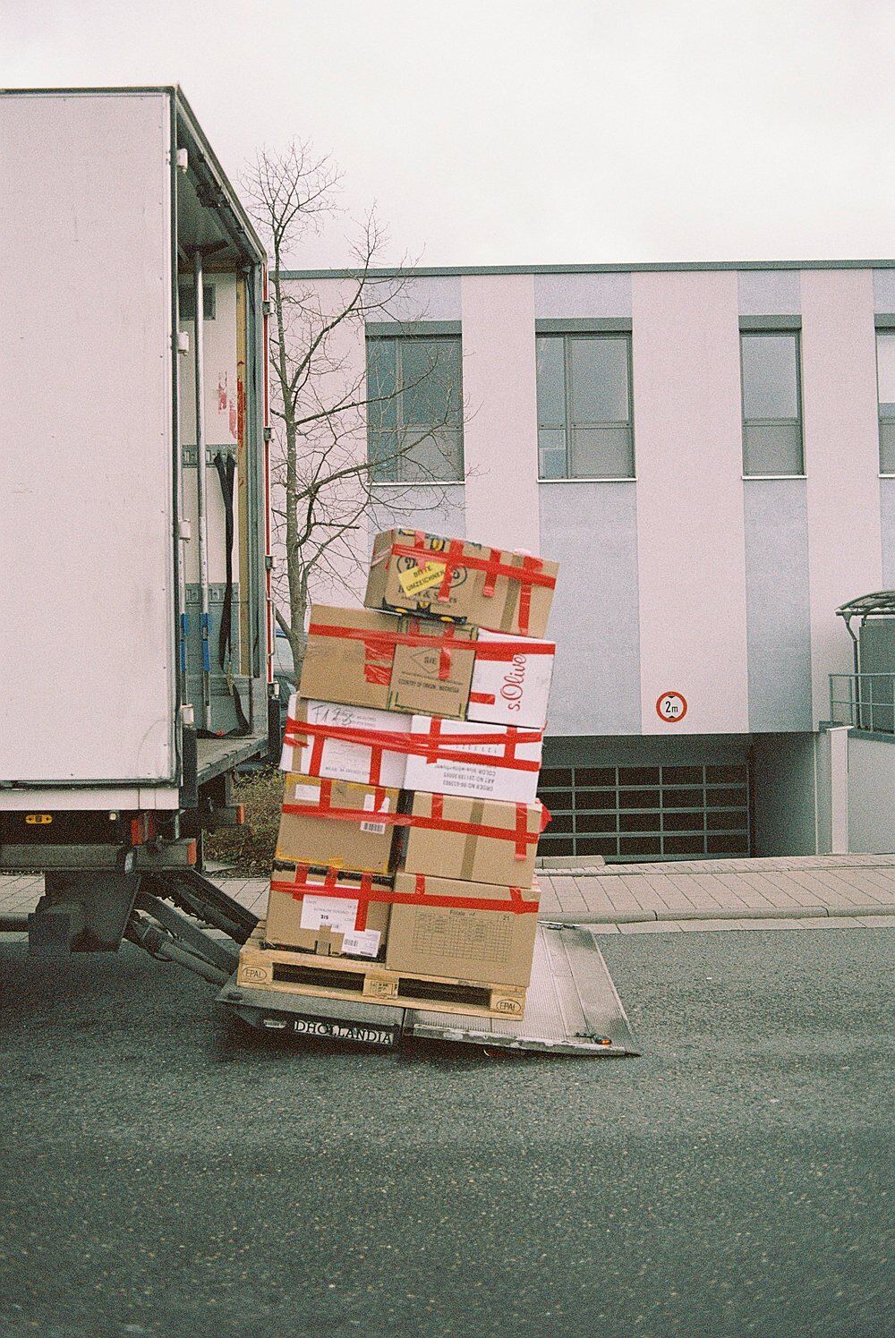 Palletised consignment on a tail-lift during kerbside delivery